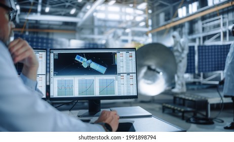 Team Of Engineers Working On Satellite Construction. Aerospace Agency International Space Mission: Diverse Group Of Scientists Developing Spacecraft, Calculate Orbital Trajectory Tracking On Computer