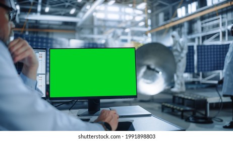 Team Of Engineers Working On Satellite Construction. Aerospace Agency International Space Mission: Professional Scientist Is Using Computer With Green Screen Mock-up Display.