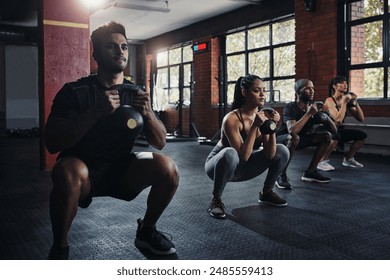 Team, exercise and workout with kettlebell to squat in class for muscle, wellness or healthy body. Group, fitness and strong people weightlifting for power, bodybuilding and training together at gym - Powered by Shutterstock