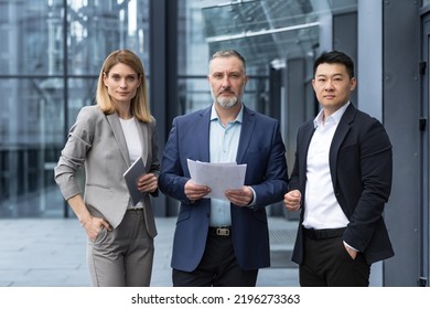 A Team Of Experienced Team Leaders And Specialists, A Diverse Group Of Business People, Three People In Business Clothes Are Serious And Focused In Business Clothes Looking At The Camera