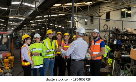 Team Of Factory Workers Or Technicians Celebrate The Success Together. Collective Appreciation And Team Effort In A Factory. Leadership In Teamwork