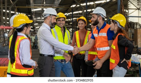 Team Of Factory Workers Or Technicians Celebrate The Success Together. Collective Appreciation And Team Effort In A Factory. Leadership In Teamwork