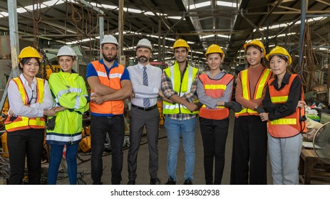 Team Of Factory Workers Or Technicians Celebrate The Success Together. Collective Appreciation And Team Effort In A Factory. Leadership In Teamwork