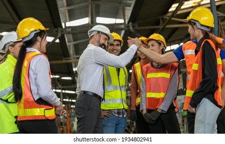 Team Of Factory Workers Or Technicians Celebrate The Success Together. Collective Appreciation And Team Effort In A Factory. Leadership In Teamwork