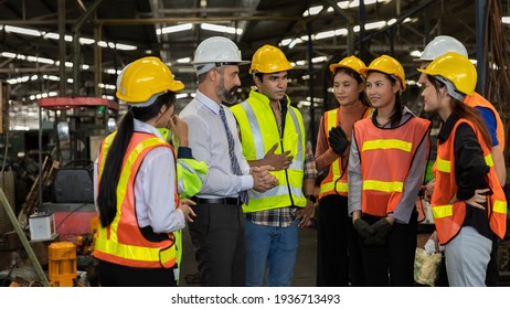 Team Of Factory Workers Or Technicians Celebrate The Success Together. Collective Appreciation And Team Effort In A Factory. Leadership In Teamwork