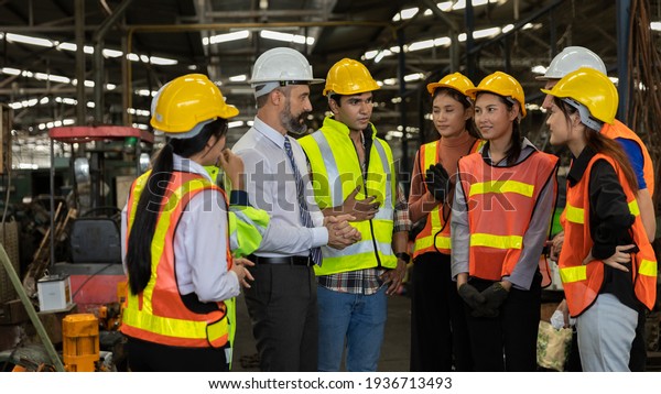 Team of factory workers or technicians celebrate\
the success together. Collective appreciation and team effort in a\
factory. Leadership in\
teamwork