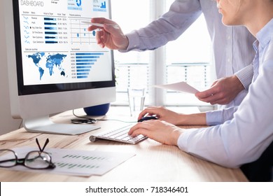 Team of financial people discussing a business analytics (BA) or intelligence (BI) dashboard on the computer screen showing sales and operations data statistics and key performance indicators (KPI) - Shutterstock ID 718346401