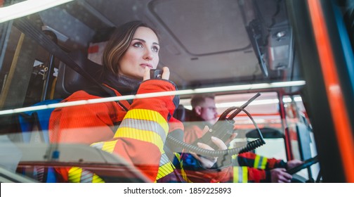 Team Of Fire Fighters Driving To An Operation Using Radio