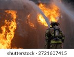 Team of firefighter in fireproof clothe using twirl fog watering hose to put out the burning crashing plane with high flame for fire extinguish risk rescue mission and accident