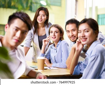 Team Of Five Businesspeople Asian And Caucasian Man And Woman Taking A Group Photo.