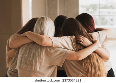 team of girls standing round and hug each other, team spirit and motivation - Powered by Shutterstock