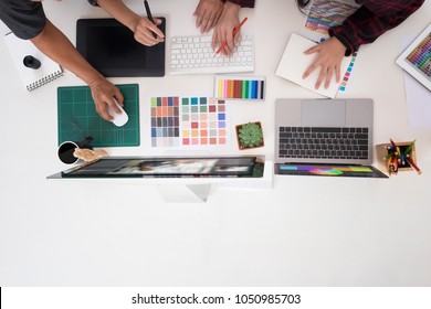 Team Of Graphic Designers Working On A Computer In OfficeIdeas Creative Occupation Design Studio,artist Workplace With Top View.