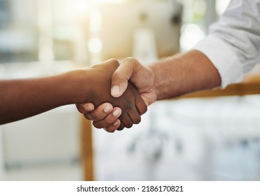 A team handshake in agreement between colleagues and coworkers in an office. Working together as a team to achieve success, merge as a partnership or promote a business person at work closeup - Shutterstock ID 2186170821