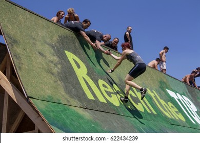 A Team Is Helping A Woman To Climb A Wall In The Strength Race Legion Run Held In Sofia, Bulgaria On 26 July 2014