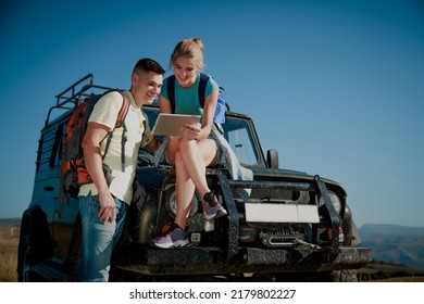 Team Of Hiking People Using Internet And Tablet Computer Pc Guide Book
