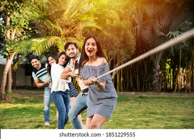 Team Of Indian Asian Young Friends Team Playing Or Competing In Tug Of War Or Rassi Khech