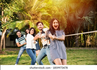 Team of Indian asian young friends Team playing or competing in tug of war or rassi khech - Powered by Shutterstock