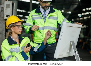 Team Industrial engineer work on personal computer She designs robot AI Model, Her male colleague talks with her and uses computer. Inside the Heavy Industry Factory. - Shutterstock ID 1823627564