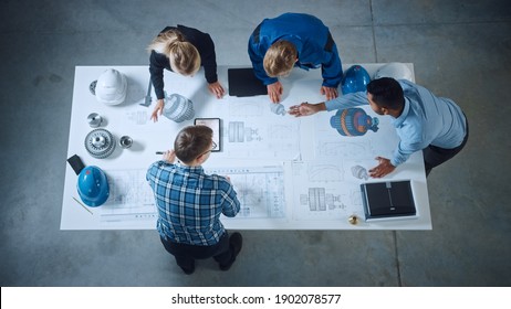 Team of Industrial Engineers Lean on Office Table, Analyze Machinery Blueprints, Architectural Problem Solving, Consult Project on Tablet Computer, Inspect Metal Component. Flat Lay Top Down View