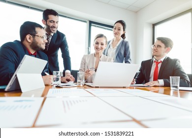 Team of international office workers discussing business development - Shutterstock ID 1531839221