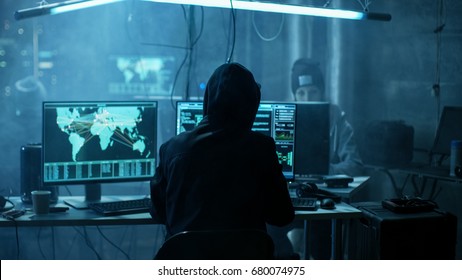 Team of Internationally Wanted Teenage Hackers Infect Servers and Infrastructure with Ransomware. Their Hideout is Dark, Neon Lit and Has Multiple displays.