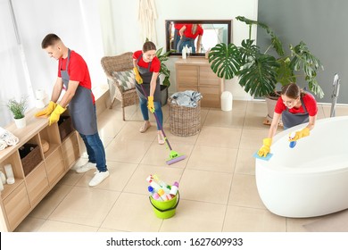 Team Of Janitors Cleaning Bathroom