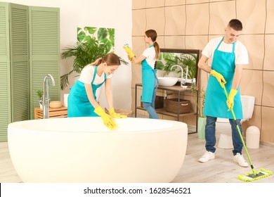 Team Of Janitors Cleaning Bathroom