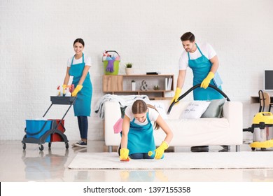 Team Of Janitors Cleaning Flat