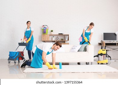 Team Of Janitors Cleaning Flat