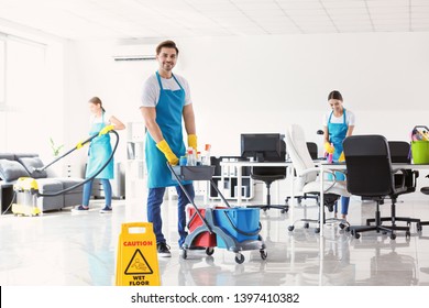 Team of janitors cleaning office - Shutterstock ID 1397410382
