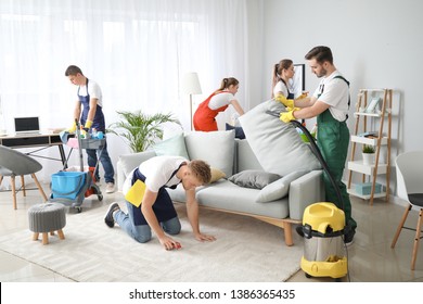 Team Of Janitors Cleaning Room