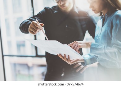 Team job succes.Photo young business managers  working with new startup project in modern office.Analyze document, plans. Holding papers, documents hands. Horizontal, blurred - Shutterstock ID 397574674