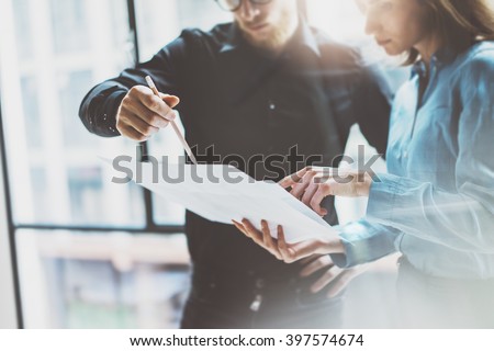 Team job succes.Photo young business managers  working with new startup project in modern office.Analyze document, plans. Holding papers, documents hands. Horizontal, blurred