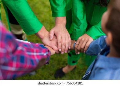 team of kids and adults holding hands together - Shutterstock ID 756354181