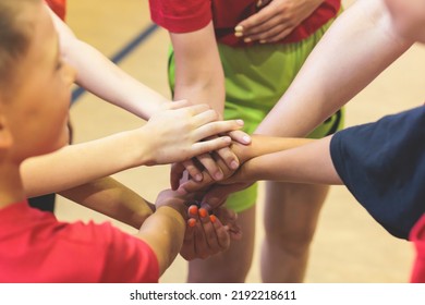 Team Of Kids Children Basketball Players Stacking Hands In The Court, Sports Team Together Holding Hands Getting Ready For The Game, Playing Indoor Basketball, Team Talk With Coach, Close Up Of Hands