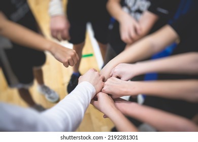 Team Of Kids Children Basketball Players Stacking Hands In The Court, Sports Team Together Holding Hands Getting Ready For The Game, Playing Indoor Basketball, Team Talk With Coach, Close Up Of Hands