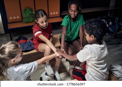 Team Of Kids Team Doing High Five Before Match Or Training.