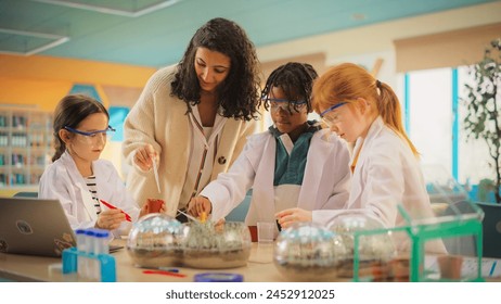 Team of Kids Finishing a Science Project. Talented Boys and Girls Growing Experimental Plants in a School Laboratory. Primary School Classroom with Children Studying Science, Biology and Chemistry - Powered by Shutterstock