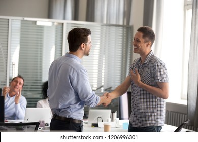 Team Leader Or Ceo Motivating Rewarding Male Employee Shaking Hand Congratulating With Promotion Achievement, Appreciating Good Work Results, Expressing Respect Support While Colleagues Applauding