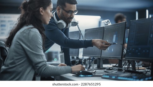 Team Leader Having a Conversation with a Female Software Engineer. Team Working on an Artificial Intelligence Neural Network. Colleagues Mapping Out Issues in a Digital Big Data Visualization Diagram