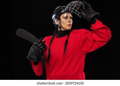 Team Leader. Professional Female Hockey Player In Special Protective Helmet, Uniform And Stick Isolated Over Black Background. Concept Of Sport, Action, Movement, Health. Copy Space For Ad