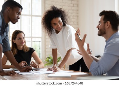 Team Leader Talk At Briefing Express Point Of View To Diverse Teammates, Multiracial Young Workers Brainstorming In Board Room Discuss New Project, Process Of Negotiations At Business Meeting Concept