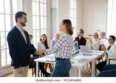 Team Leader Thanking Best Employee For Work Achievements. CEO And Manager Shaking Hands. Staff Welcoming And Applauding New Hired Employee In Conference Room. Recognition, Acknowledgement Concept