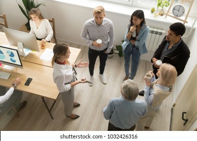 Team Leaders Meet Multiracial Interns In Office Explaining New Job, Company Executives Talking To Diverse Workers Listening Instructions At Break, Discussion And Computer Work In Coworking, Top View