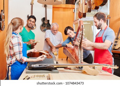 Team of luthiers working together at workshop - Powered by Shutterstock