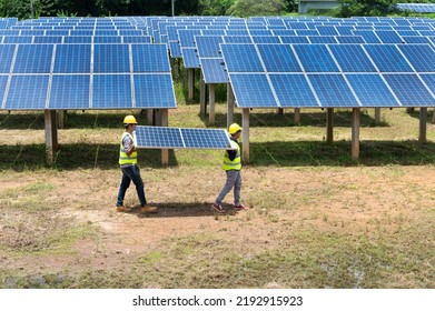 A Team Of Male Engineers Is About To Install Solar Panels. At The Solar Power Station Engineer Team Ordered And Installed Solar Cells.