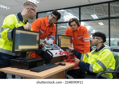 Team male engineers discuss and using desktop computer training Programmable logic controller or Programmable controller in the manufacturing automation and robotics academy room - Shutterstock ID 2248590911