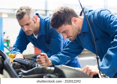 Team Of Mechanics Working Together At The Repair Garage