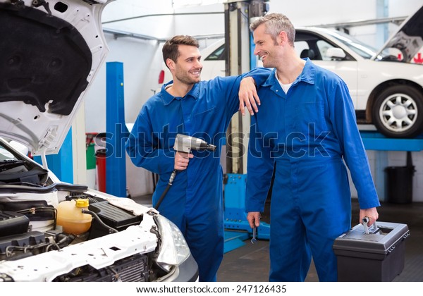 Team\
of mechanics working together at the repair\
garage