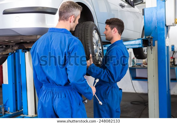 Team\
of mechanics working together at the repair\
garage